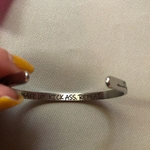 New in bag silver cuff bracelet with Wake up, kick ass, repeat engraved inside